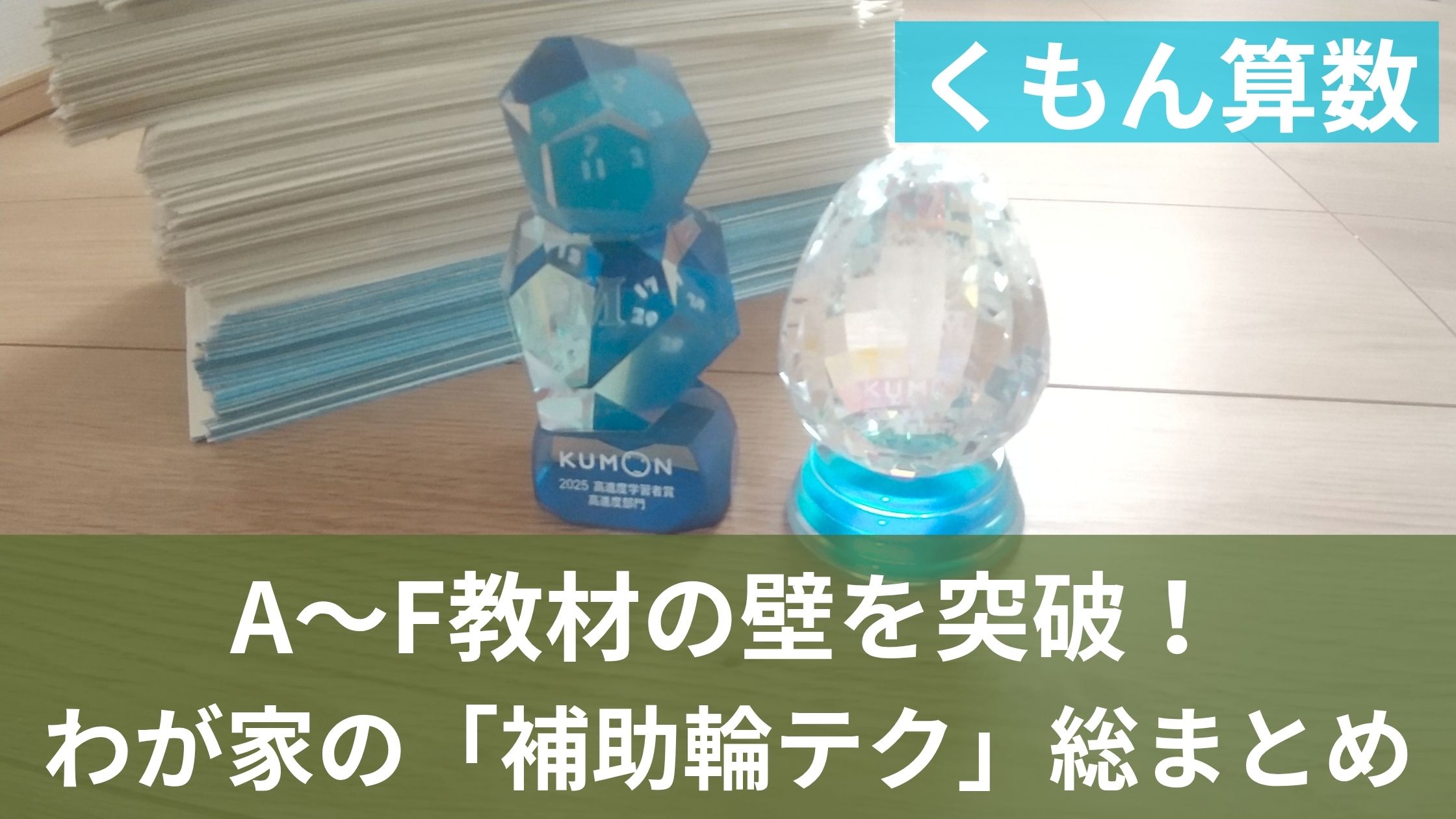 公文プリントの山とトロフィ
